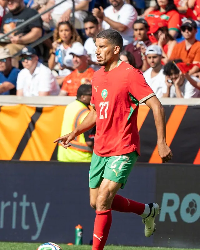 Marwane Saadane running in Morocco kit during a match