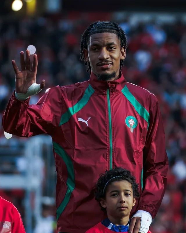 Redouane Halhal greeting supporters while wearing Morocco team clothing