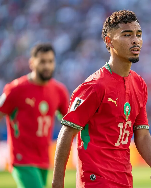 Yassine Gessime standing on the pitch in Morocco's number 16 shirt