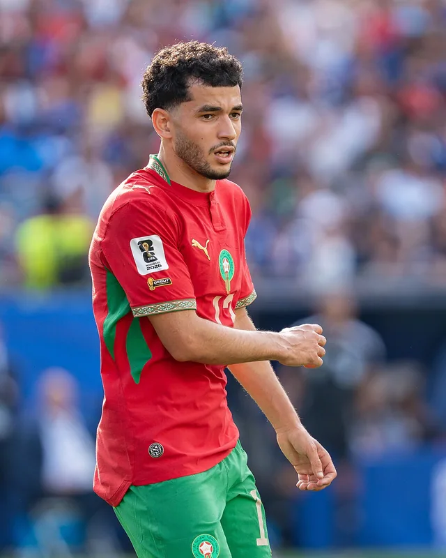 Zakaria El Ouahdi walking on the pitch in Morocco kit