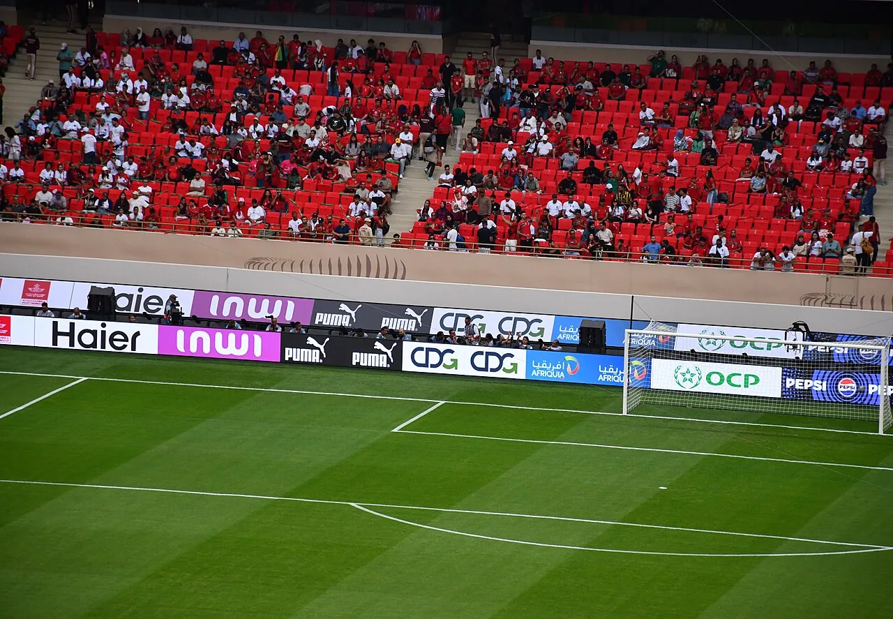 Goal area and lower red seating filled with Morocco supporters at Prince Moulay Abdellah Stadium