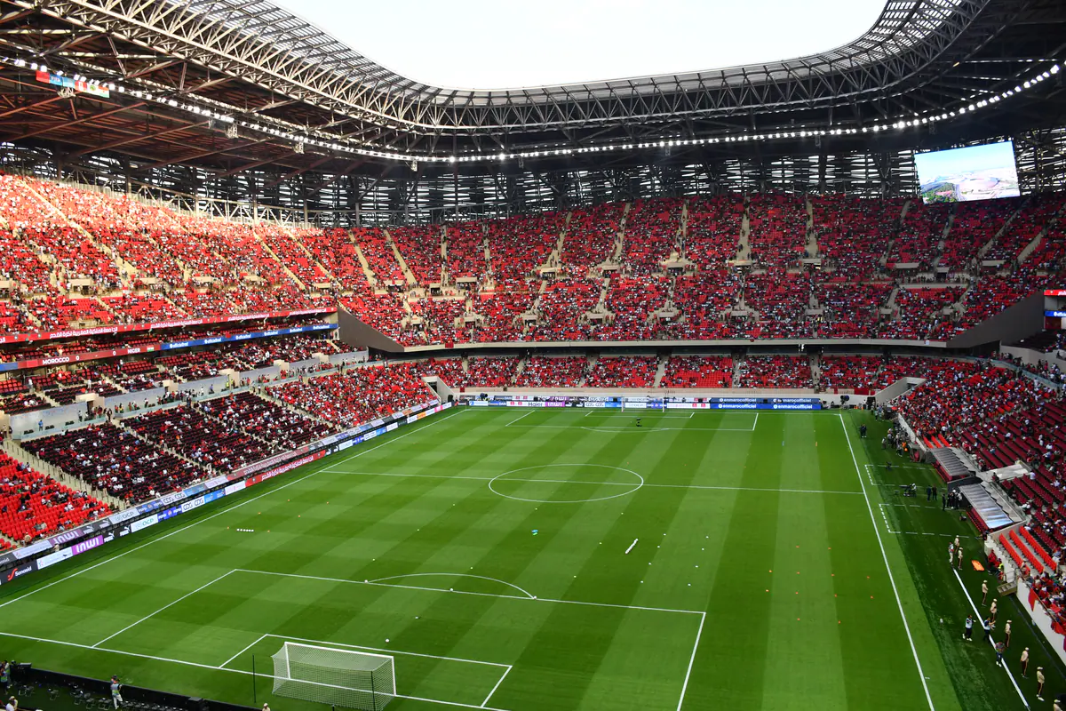 Real photograph of the football pitch, red stands and roof inside Prince Moulay Abdellah Stadium in Rabat